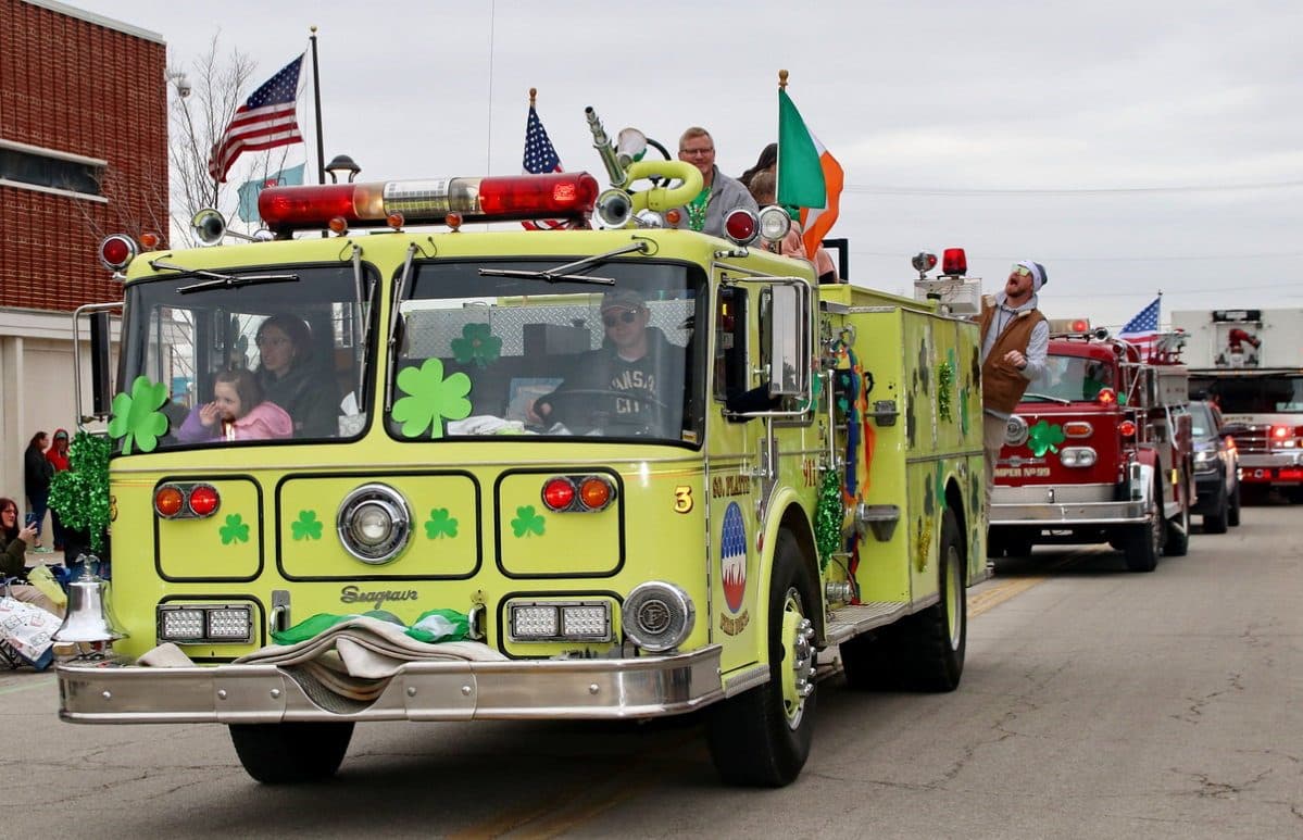 A lime-green fire truck decorated with shamrocks